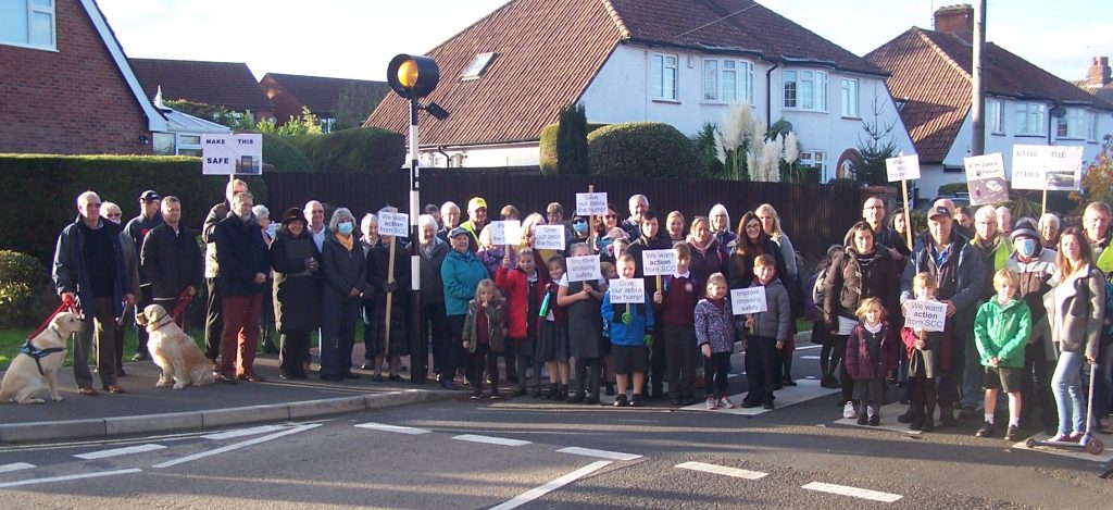 About 50 adults and children standing on the Wembdon Rise zebra crossing as a show of public concern