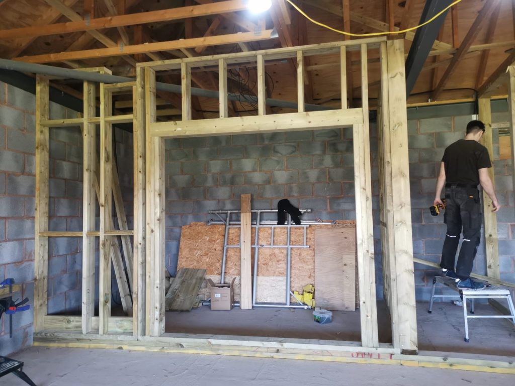 Stud wall with doorway underconstruction in the upstairs room at The Green