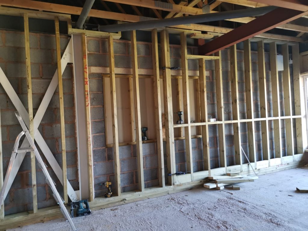 Stud wall underconstruction in the upstairs room at The Green